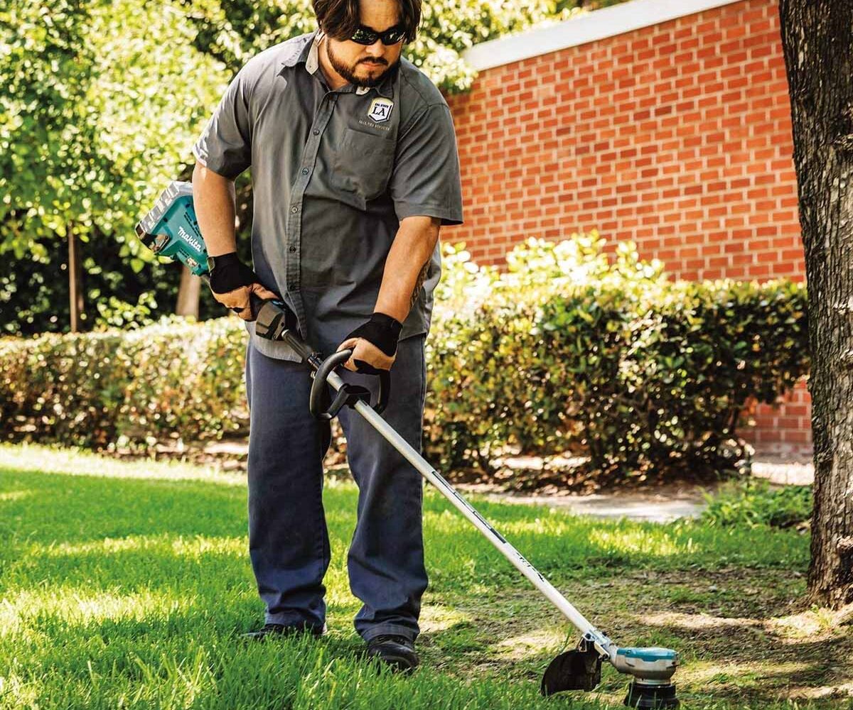 A guy using a Makita string trimmer